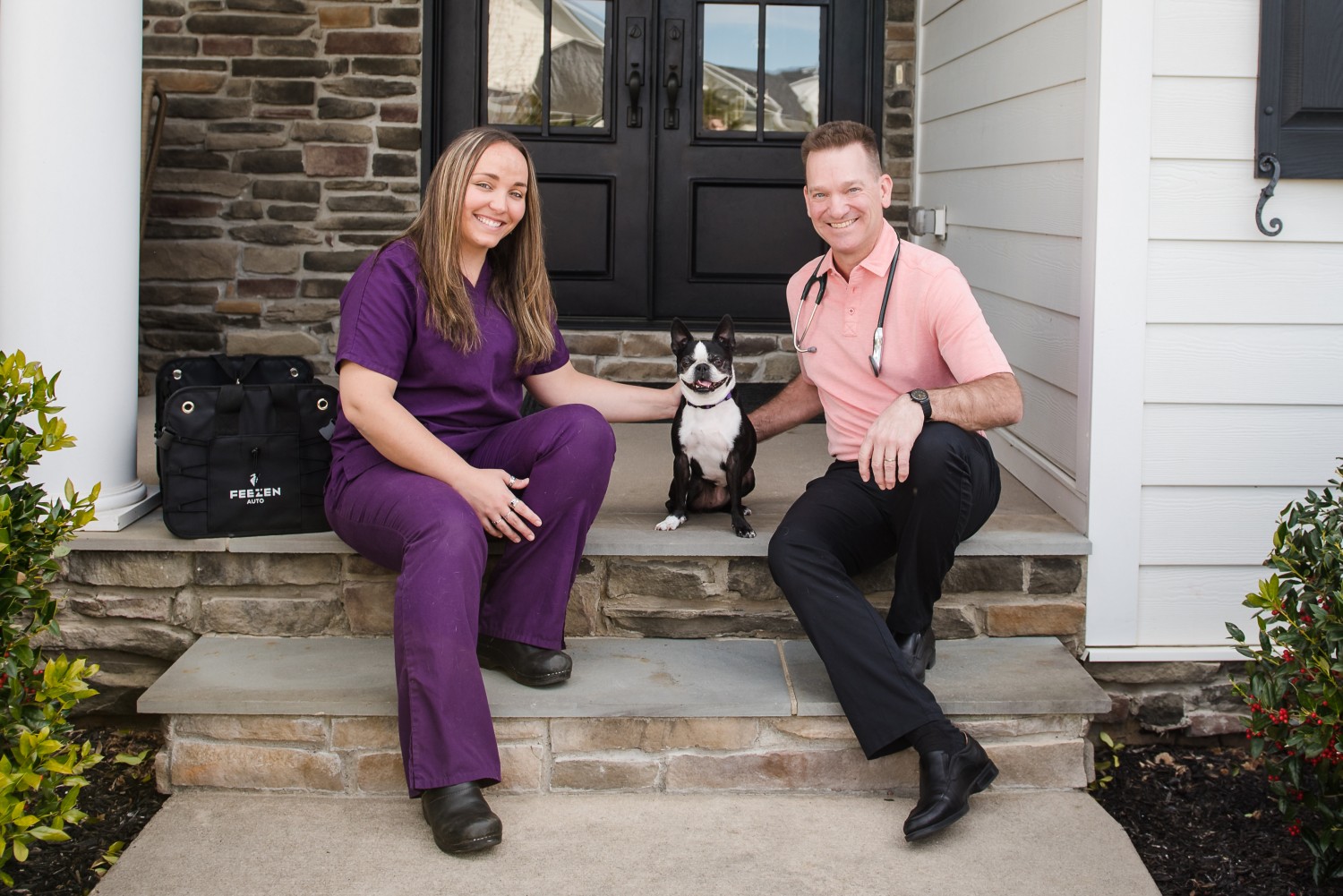 Trista and Dr. George Belbey on front porch with a dog